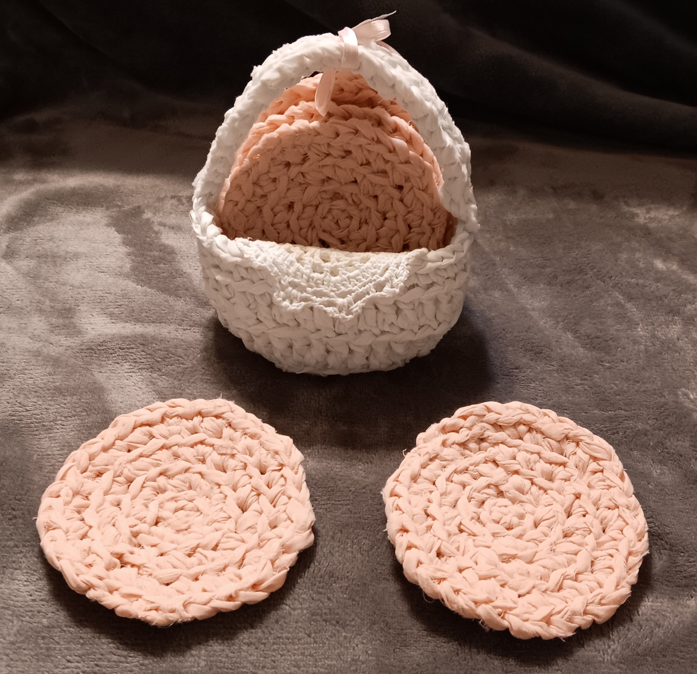 Handmade pink coasters in white basket