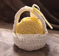 Handmade yellow coasters in white basket