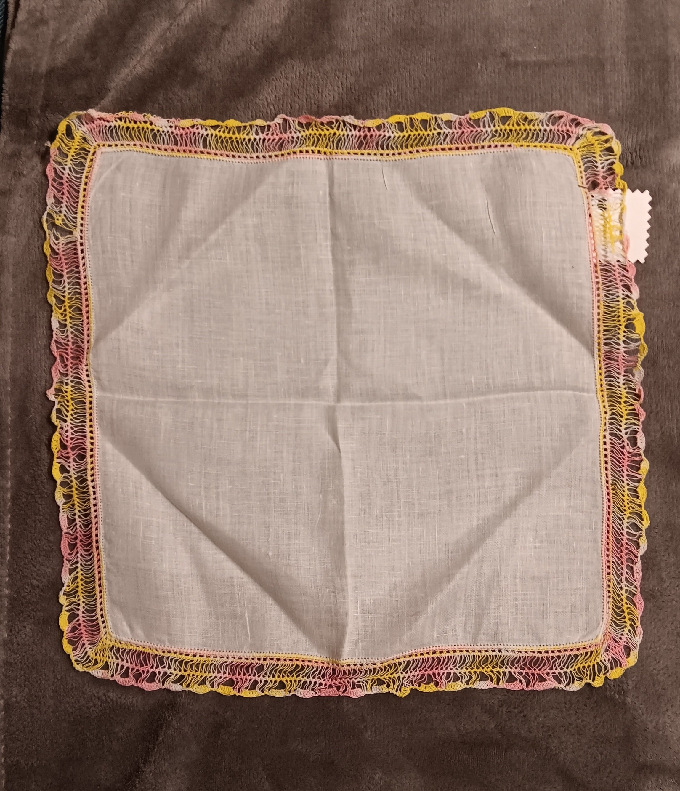 White handkerchief with pink and yellow lace