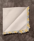 White handkerchief with blue and yellow lace