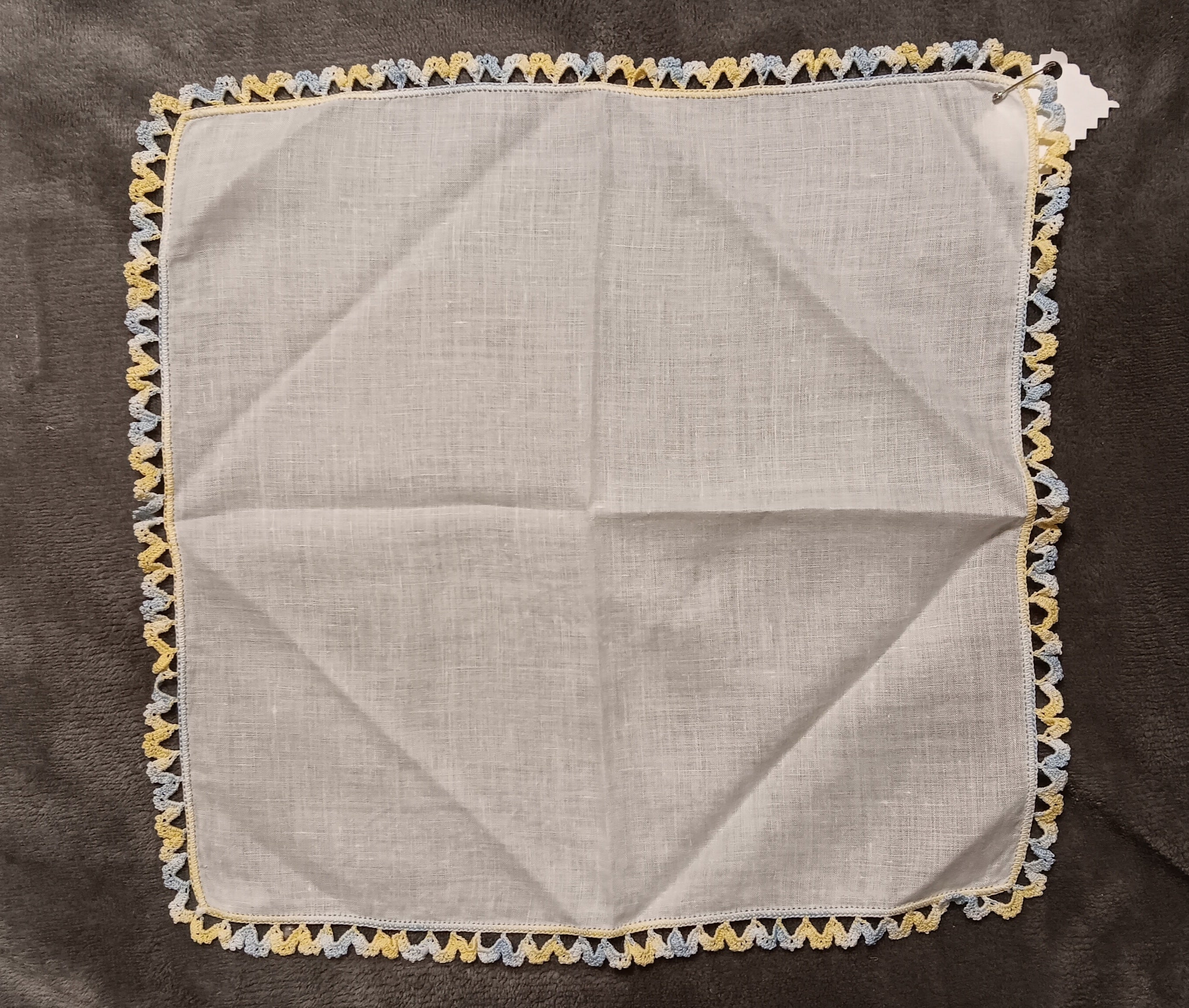 White handkerchief with blue and yellow lace